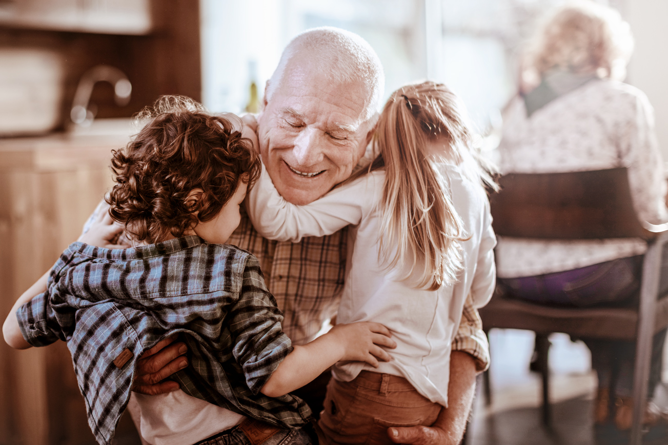 Close up of a grandfather playing with his grandkids